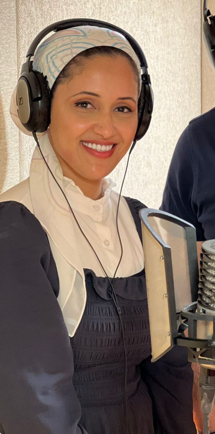 Marwa smiling in a recording booth