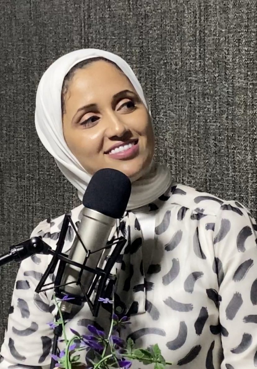 Marwa Gouda smiling beside a studio microphone